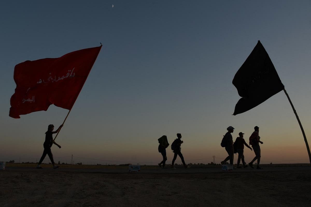 Iraqi Shiite Muslim pilgrims march from the country's southern city of Nasiriyah in the Dhi Qar province to the holy city of Karbala, ahead of the Arbaeen religious festival. Credit: AFP Photo