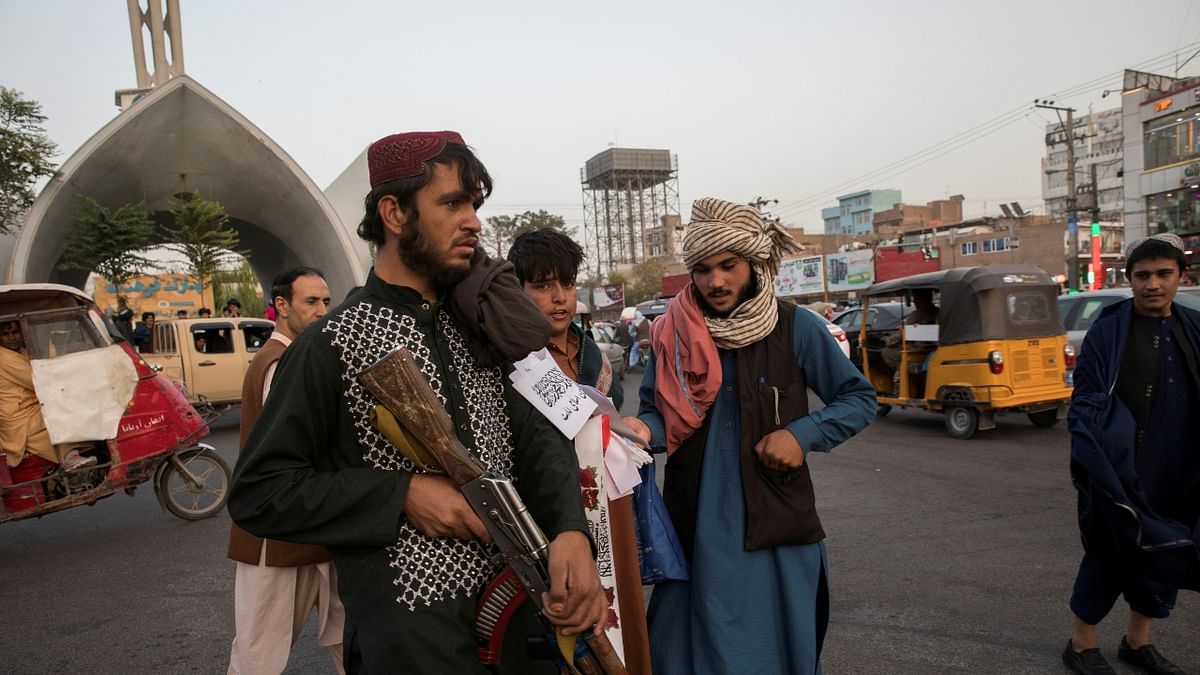 Taliban soldiers stand guard in a street in Herat, Afghanistan. The Taliban said a group will investigate reports of atrocities and protect people's rights. Credit: Reuters Photo