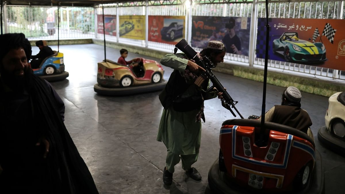 A Talibani soldier is seen enjoying a car ride at an amusement park in Kabul, Afghanistan. Credit: Reuters Photo