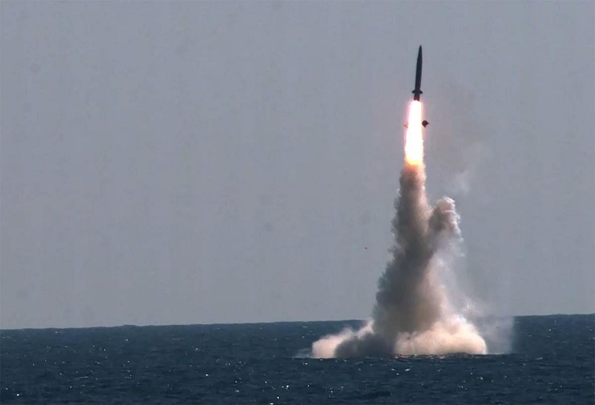 This video grab from handout footage taken on September 15, 2021 and released by the South Korean Defence Ministry in Seoul shows the test firing of a submarine-launched ballistic missile at sea. Credit: AFP Photo