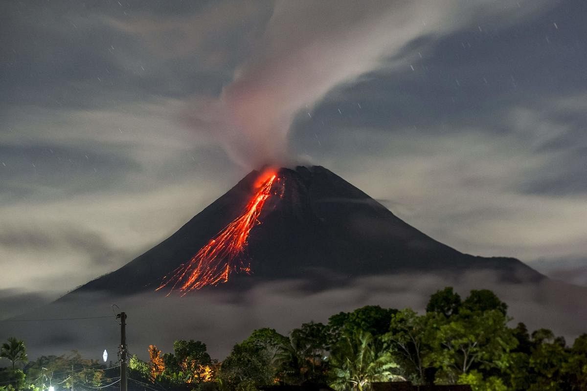 Lava flows down and smoke rises into the air from Mount Merapi, Indonesia's most active volcano, as seen from Wonokerto in Sleman. Credit: AFP Photo