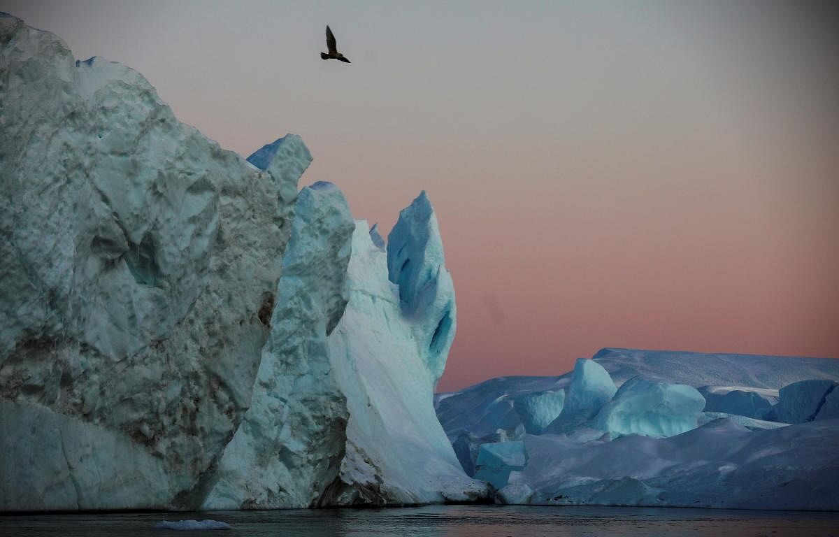 Icebergs are seen at the at the mouth of the Jakobshavns ice fjord during sunset near Ilulissat, Greenland. Credit: Reuters Photo