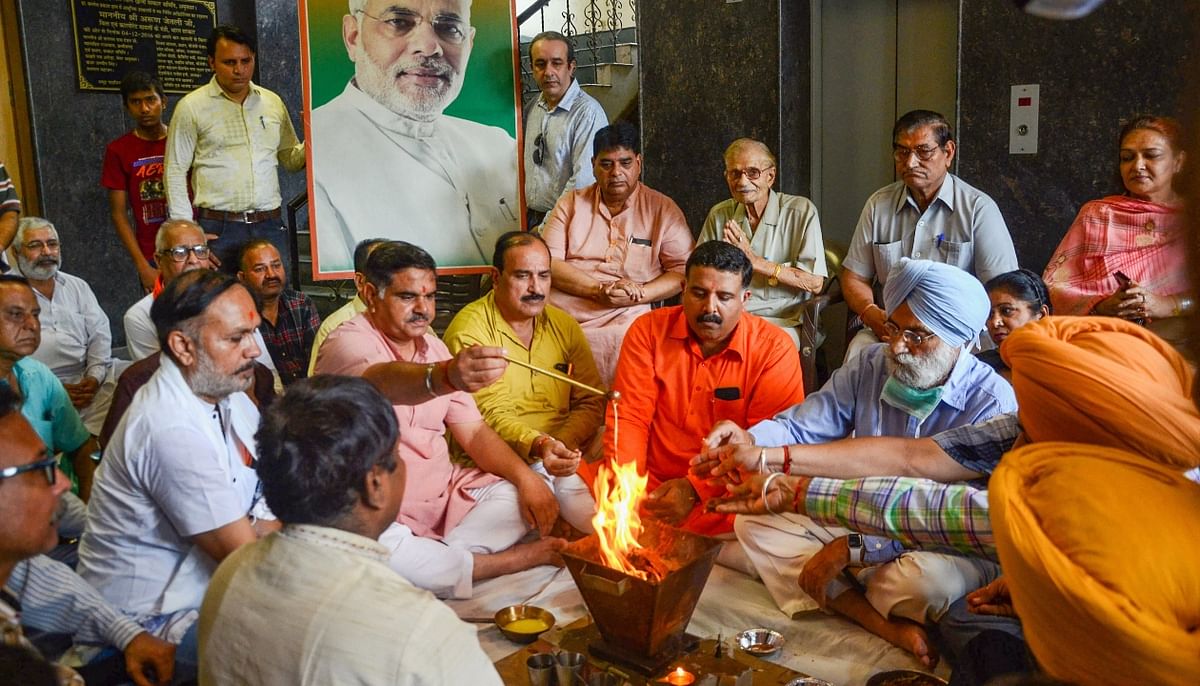 BJP leader and workers perform rituals at BJP office to celebrate 71st birthday of Prime Minister Narendra Modi, in Amritsar. Credit: PTI Photo