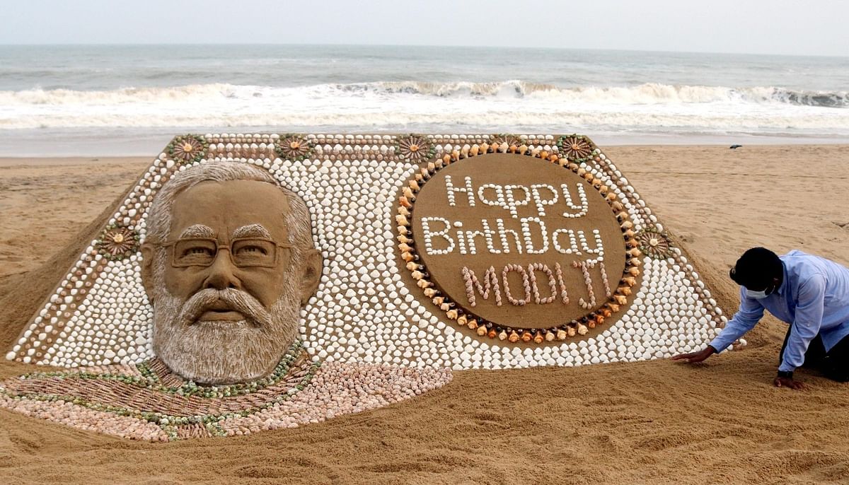 Sand artist Sudarsan Pattnaik wished PM Modi with this sand sculpture using 2,035 seashells, at Puri beach in Odisha. Credit: PTI Photo