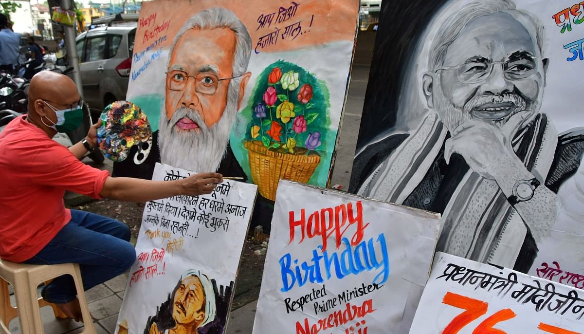 Artists make paintings of PM Narendra Modi to wish him on his birthday, at Lalbaug, in Mumbai. Credit: PTI Photo