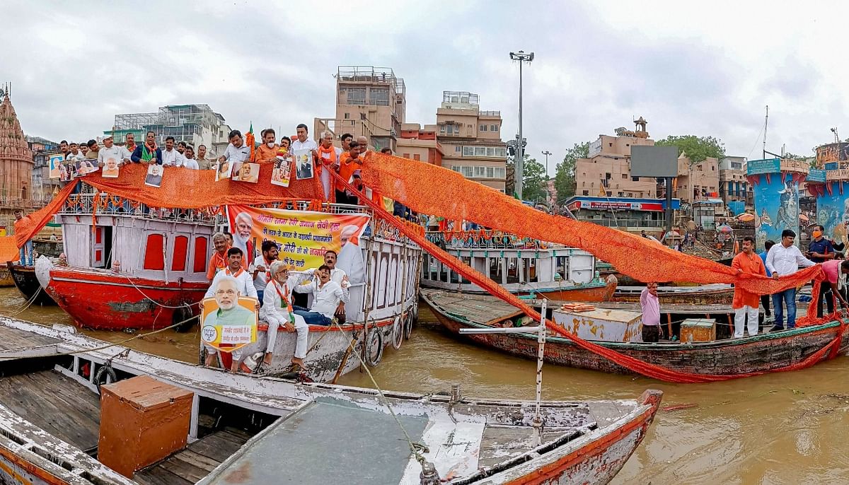 BJP supporters stand on boats as they hold a 71 metre saree on the banks of river Ganga to celebrate 71st birthday of Prime Minister Narendra Modi, in Varanasi. Credit: PTI Photo