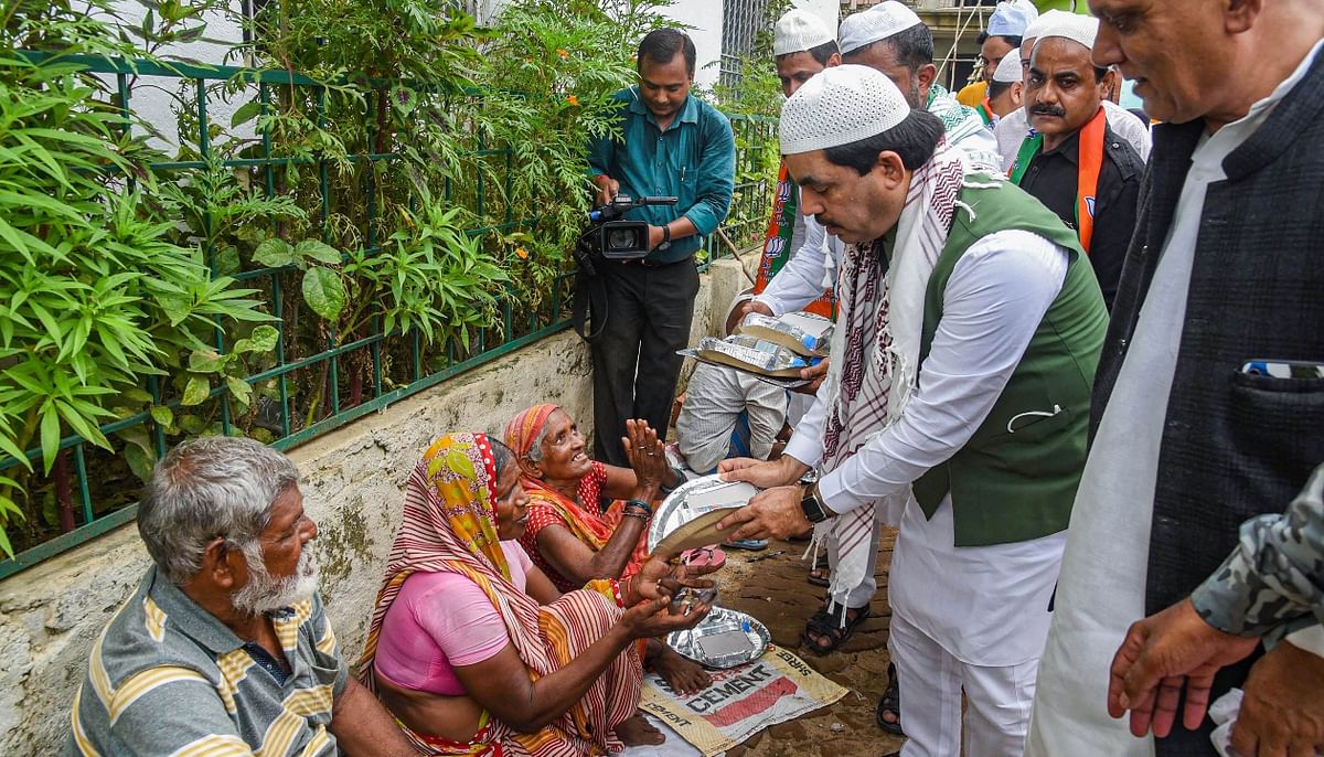 Bihar state minister Shahnawaz Hussain distributes food among the needy to celebrate 71st birthday of Prime Minister Narendra Modi, in Bihar. Credit: PTI Photo