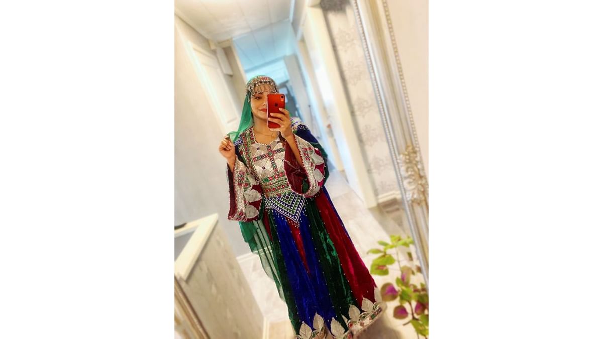 A woman poses in traditional Afghan attire, in Stockholm, Sweden. Credit: Twitter/@dressingsonnets