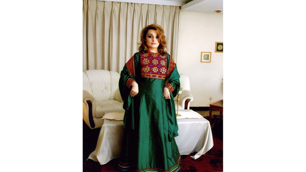 A woman poses in traditional Afghan attire, in Kabul, Afghanistan. Credit: Twitter/@dressingsonnets