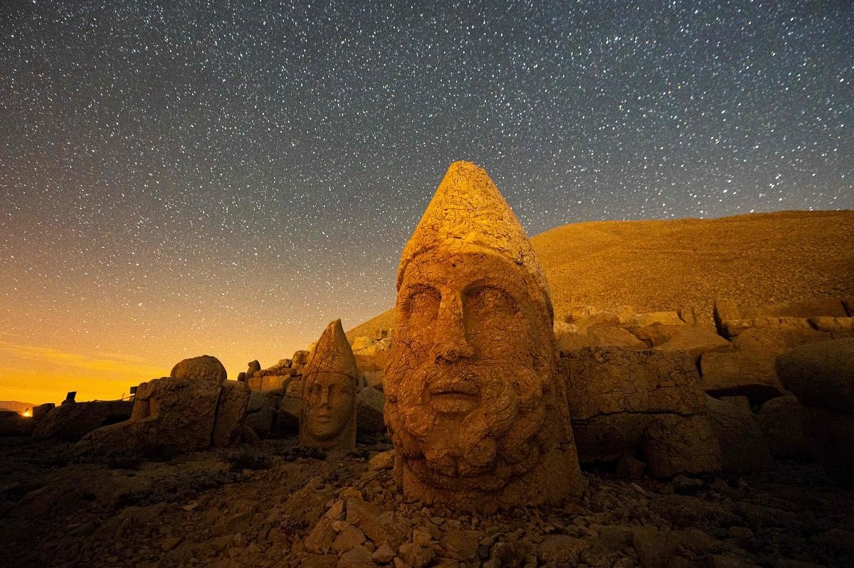 Large stone head statues at the archaeological site of Mount Nemrut in Adiyaman, southeastern Turkey. This UNESCO World Heritage Site since 1987 is on a 2,134-metre-high mountain including giant 10-meter high, seated statues of King Antiochus I himself surrounded by ancient Gods, including Zeus and Apollo, was discovered in 1881 by a German engineer. Credit: AFP Photo