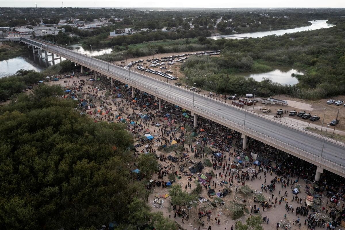 Some thousands of migrants take shelter as they await to be processed near the Del Rio International Bridge after crossing the Rio Grande river into the U.S. from Ciudad Acuna in Del Rio, Texas. Credit: Reuters Photo