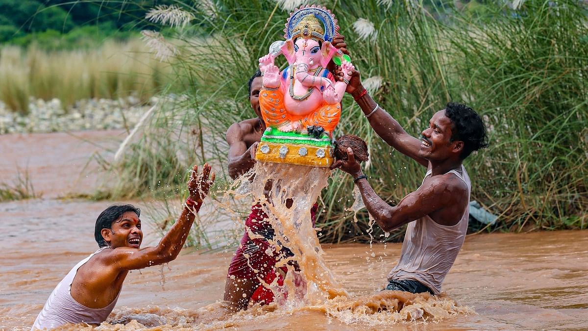 Devotees carry an idol of Lord Ganesh for immersion in the Tawi river, in Jammu. Credit: PTI Photo