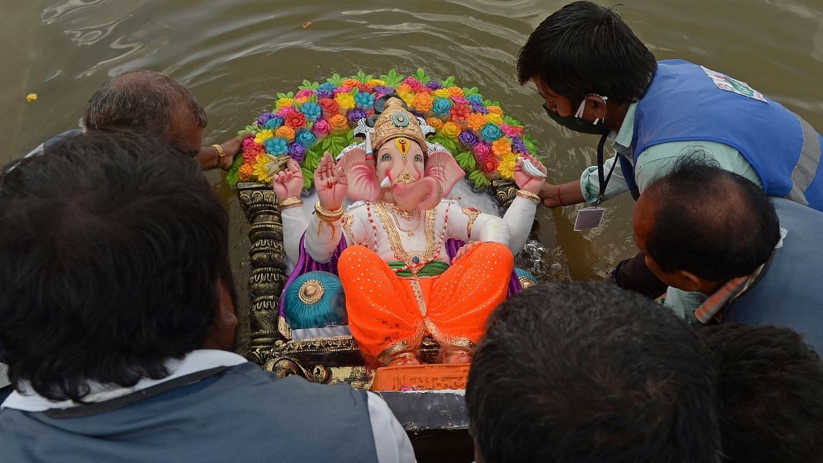 Devotees immerse an idol of Ganesha in an artificial pond during the ten-day-long Ganesh Chaturthi festival in Hyderabad. Credit: AFP Photo