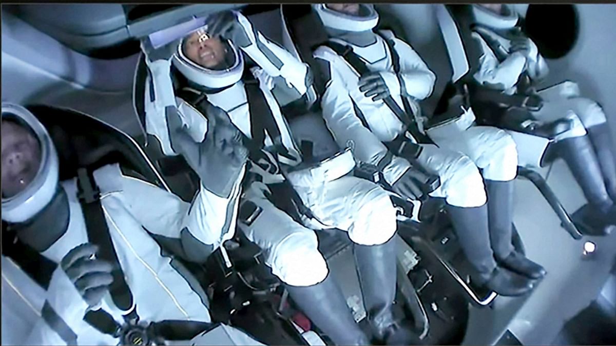 SpaceX video, passengers aboard a SpaceX capsule. Credit: AP Photo
