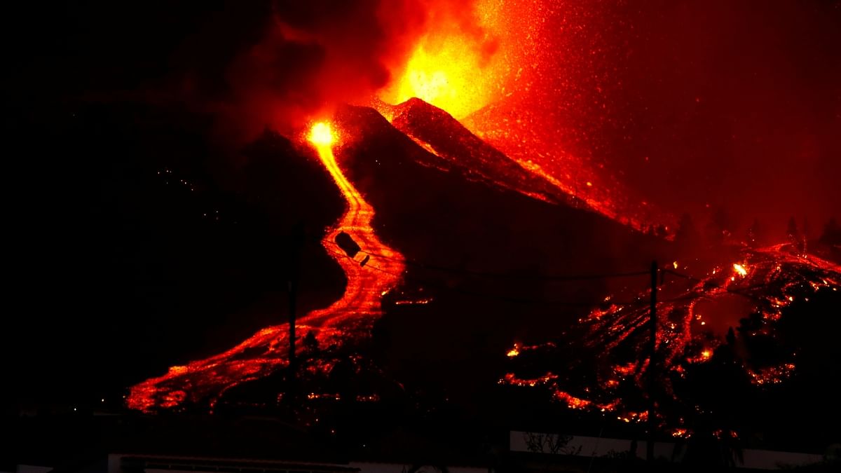 One black lava flow with a burning tip was sliding toward some houses in the village of El Paso. Credit: Reuters Photo