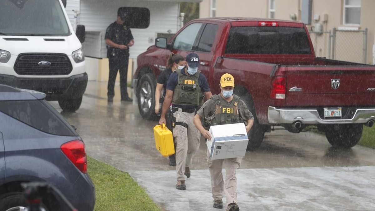 FBI agents begin to take away evidence from the family home of Brian Laundrie, who is a person of interest after his fiancé Gabby Petito went missing on September 20, 2021 in North Port, Florida. Credit: AFP Photo