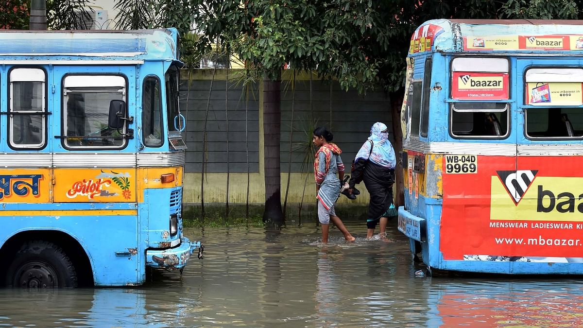 Submerged thoroughfares and low-lying areas compounded problems for commuters, who struggled to find public transport amid the torrential rain and traffic snarls while going to work. Credit: PTI Photo