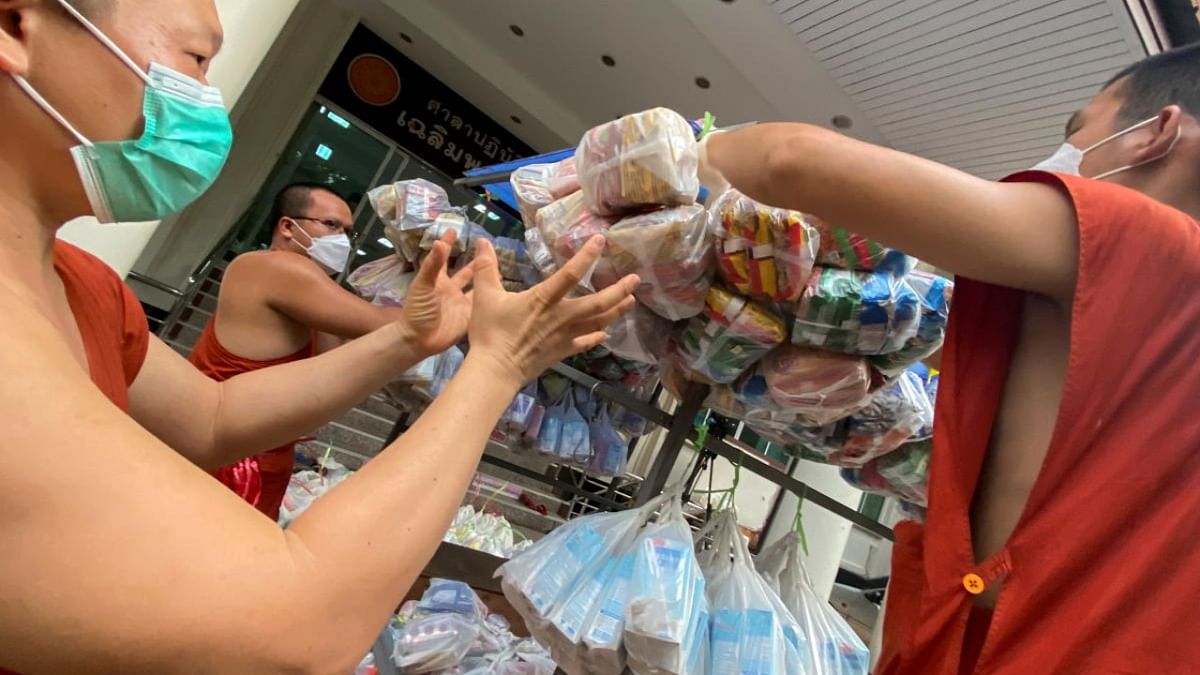 Buddhist monks from Wat Siriphong Thamma Nimit temple load food and other necessities in preparation to donate to vulnerable people whose livelihoods have been hit hard by Covid-19 pandemic on the outskirts of Bangkok, Thailand. Credit: Reuters photo
