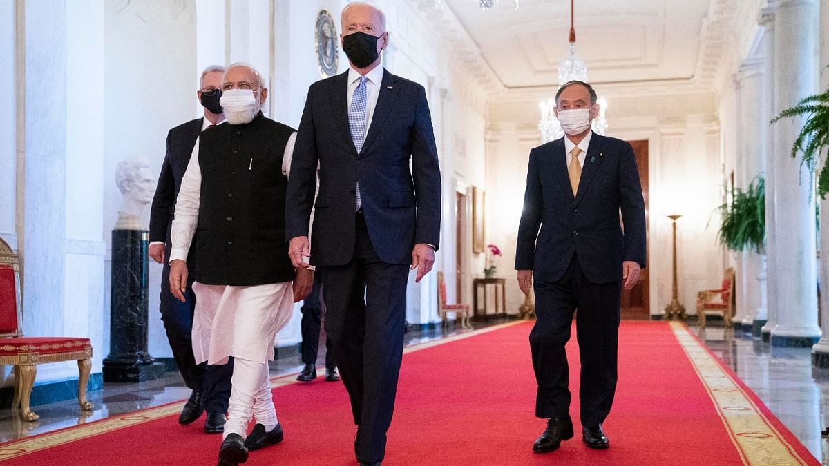 PM Modi walks to the Quad summit with US President Jo Biden, Australian Prime Minister Scott Morrison and Japanese Prime Minister Yoshihide Suga to the East Room of the White House. Credit: AP Photo