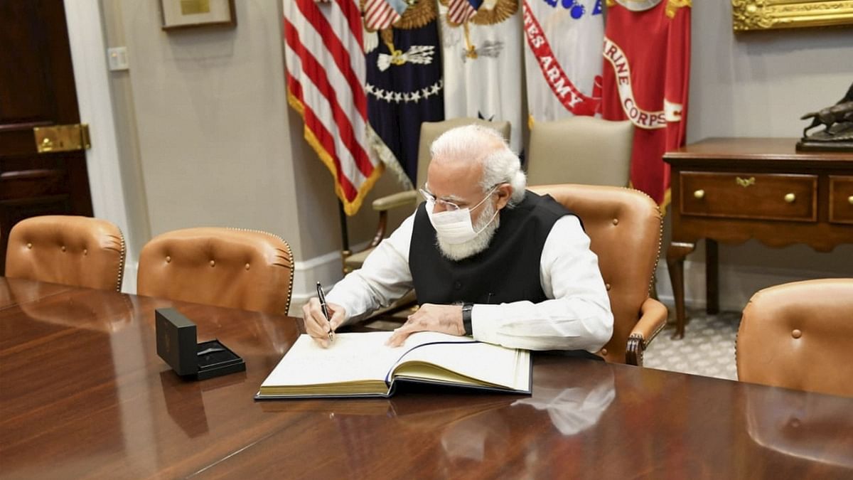 Registering the spirit of US-India friendship in ink, Modi signed the visitors' book in the Roosevelt Room here at the White House. Credit: PTI Photo