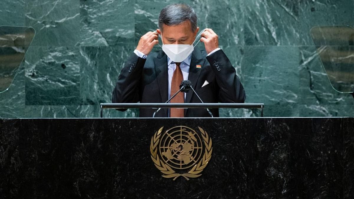 Foreign Minister of Singapore Vivian Balakrishnan removes his protective face mask before addressing the 76th session of the United Nations General Assembly at UN headquarters. Credit: AFP Photo