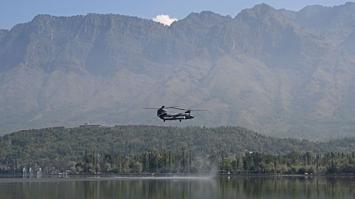 Indian Air Force (IAF) Chinook helicopter flies over Dal Lake during IAF's air show in Srinagar. Credit: AFP Photo