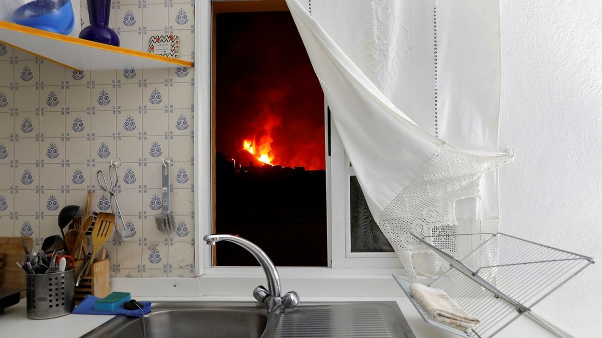 Lava is seen through the window of a kitchen from El Paso following the eruption of a volcano on the Canary Island of La Palma, Spain. Credit: Reuters Photo