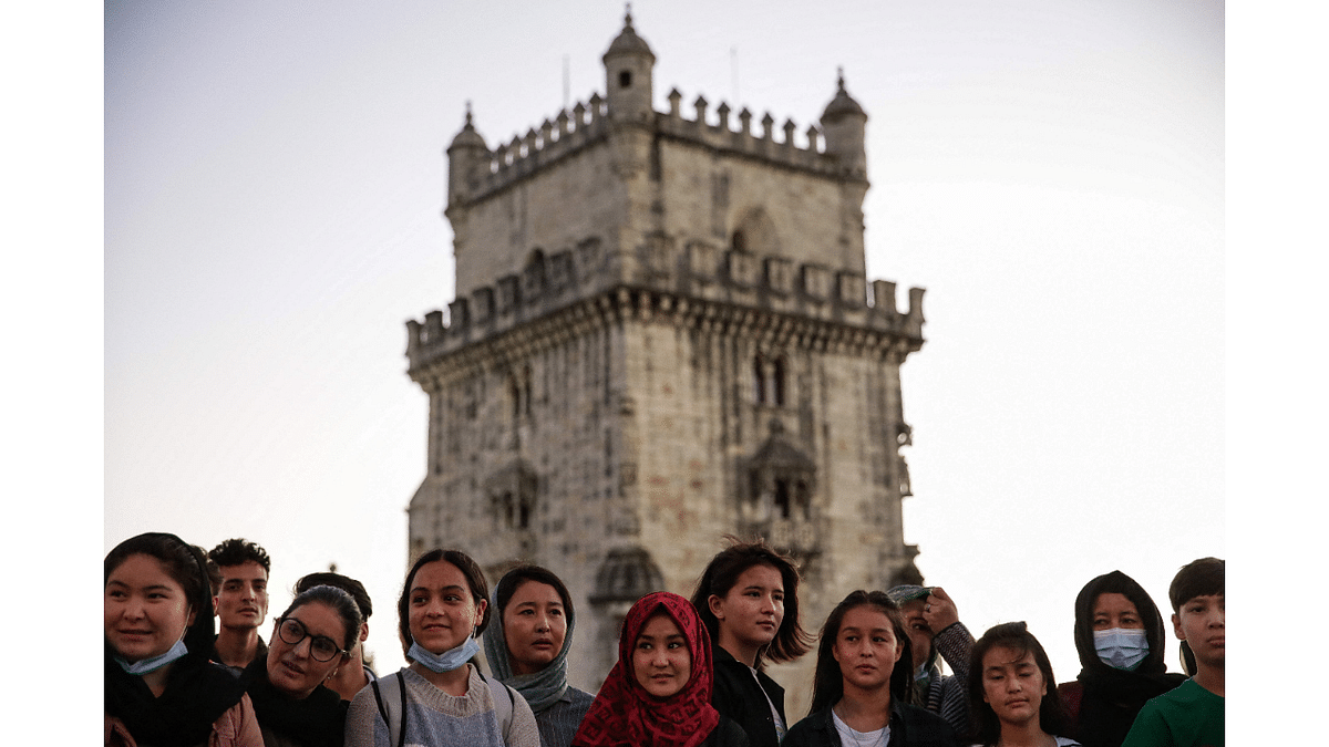Players of Afghanistan national women football team, are welcomed in Portugal, by the team's captain, at the Belem Tower in Lisbon. Credit: AFP Photo