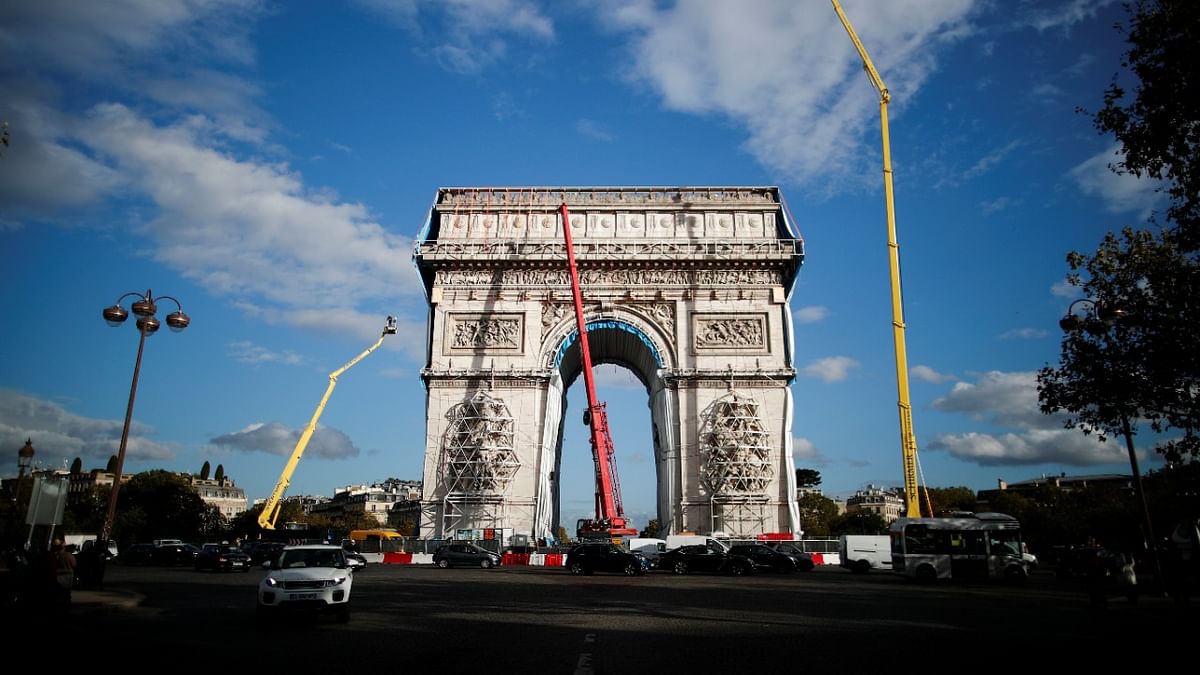 Rope access technicians work on the removal of the fully wrapped Arc de Triomphe monument, after it was wrapped for an art installation entitled 'L'Arc de Triomphe, Wrapped'. Credit: Reuters Photo