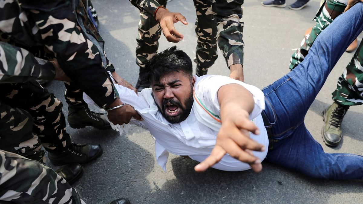 Police forces detain a man during a protest by activists of the youth wing of the Congress party outside UP Bhawan, after people were killed when violence broke out in Uttar Pradesh on Sunday. Credit: Reuters Photo