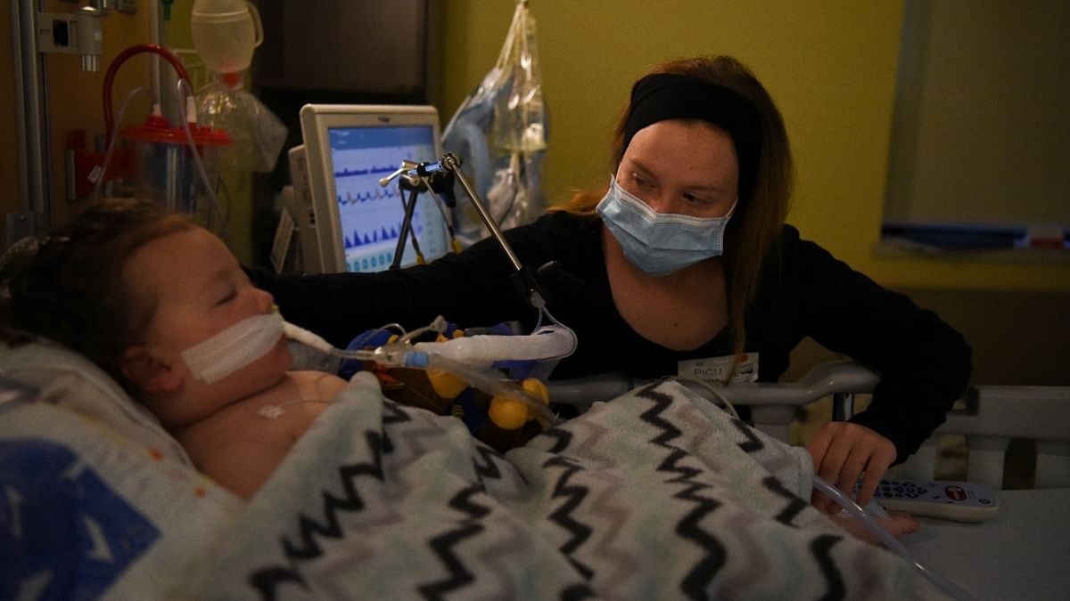 Tiffany Jackson comforts her son Adrian James, 2, who tested positive for Covid-19, as he breathes with assistance from a ventilator at SSM Health Cardinal Glennon Children's Hospital in St. Louis, Missouri, US. Credit: Reuters Photo