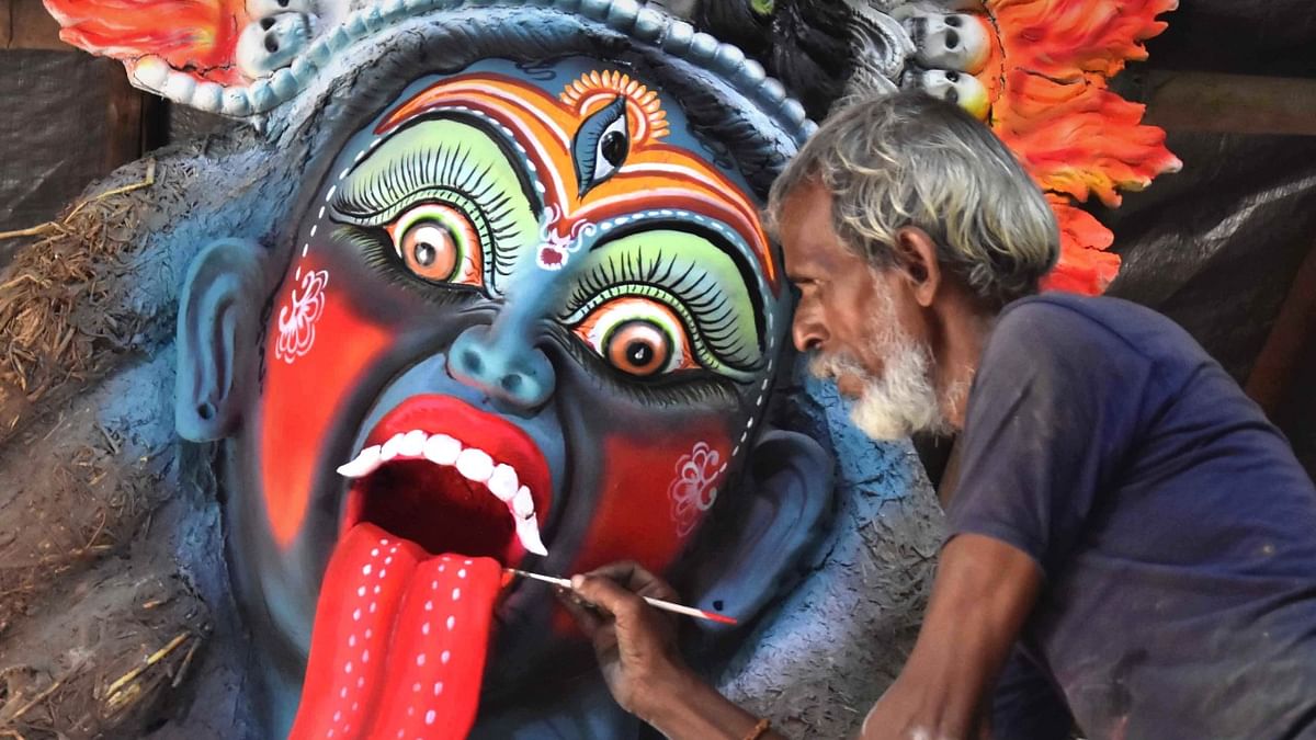 An artist gives final touch to an idol of Goddess Kali ahead of the Navratri festival, in Bhopal. Credit: PTI Photo