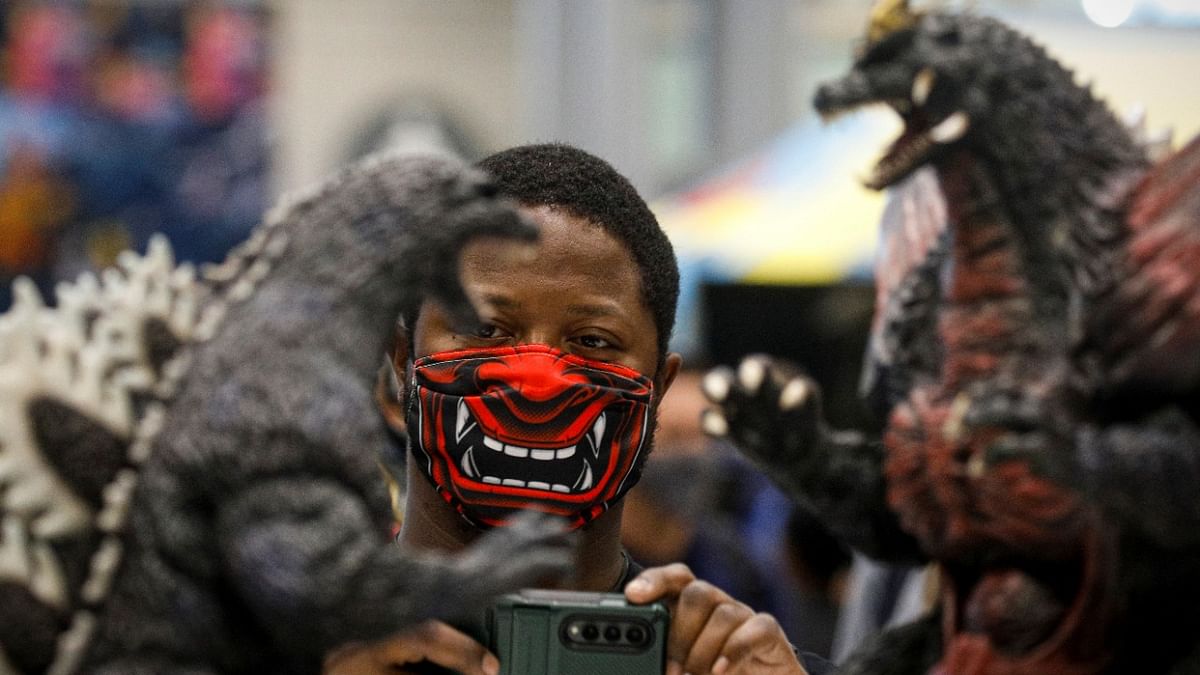 A man photographs merchandise during the 2021 New York Comic Con, at the Jacob Javits Convention Center in Manhattan in New York City. Credit: Reuters Photo