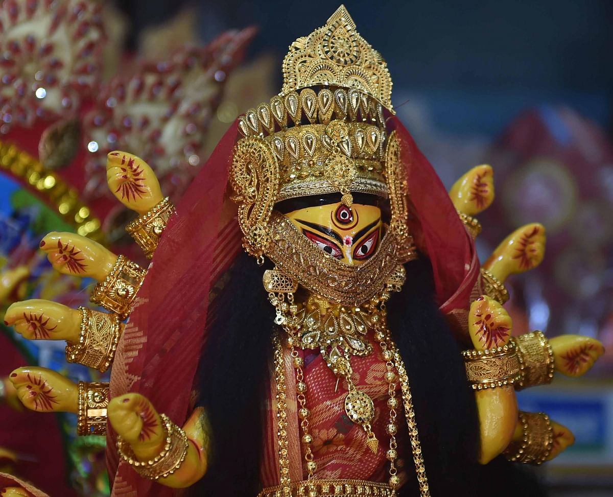 An idol of Goddess Durga decorated with a mask to spread awareness of coronavirus ahead of Durga Puja. Credit: PTI Photo