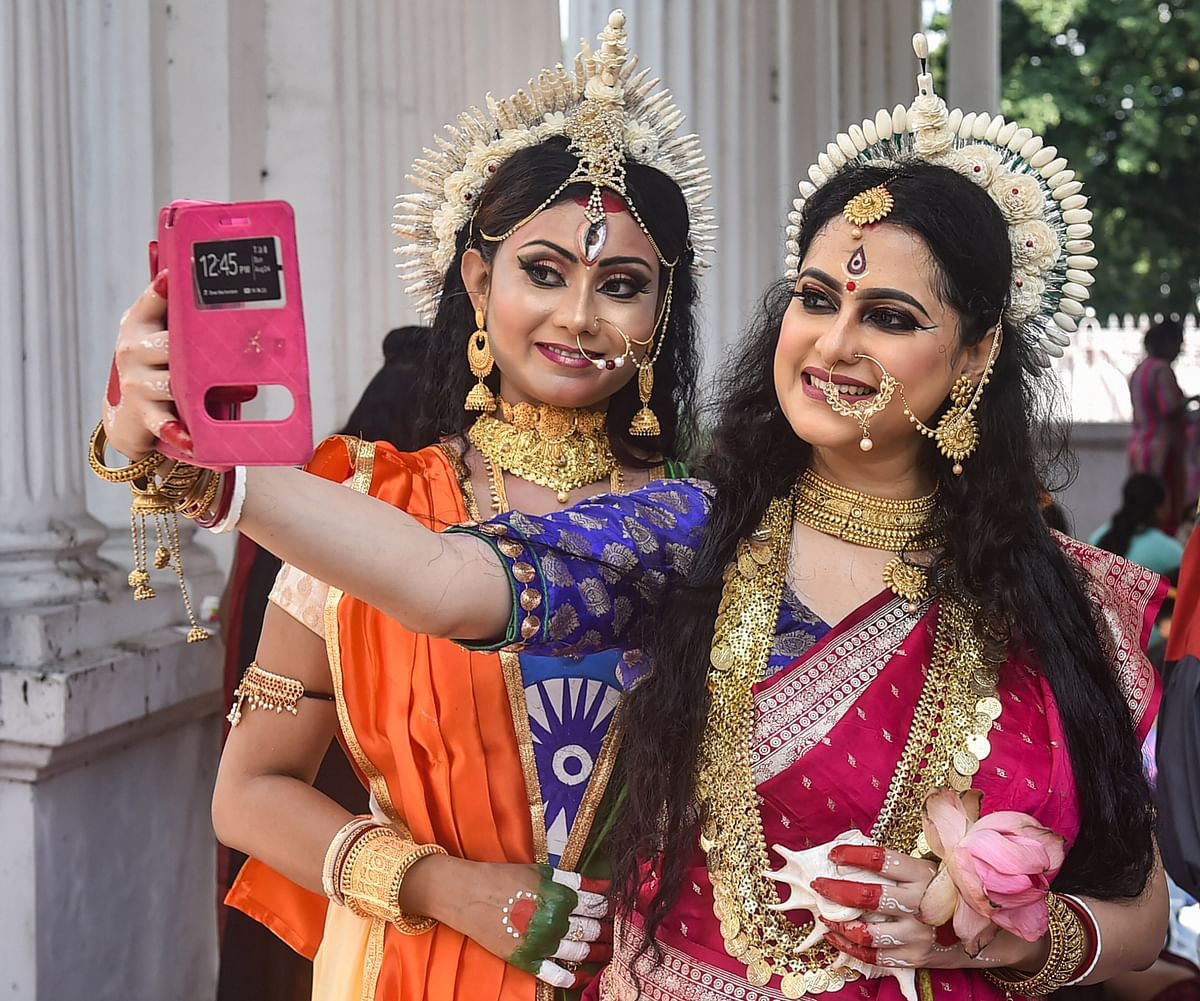 Performers attired as Goddess Durga, click a selfie during an event 'Live Durga''. Credit: PTI Photo