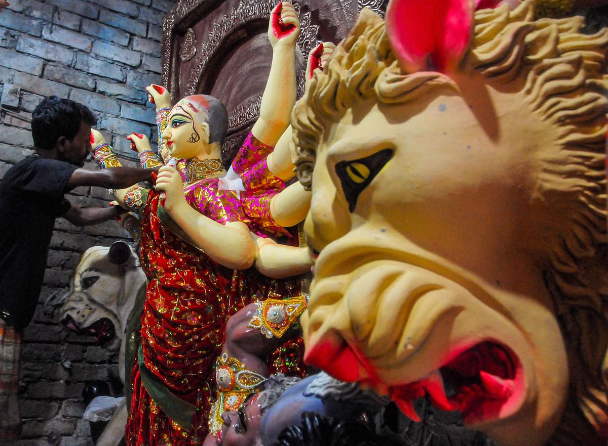 Pictured: An artist prepares Goddess Durga's clay idol ahead of Durga Puja festival in Kumartuli. Credit: PTI Photo