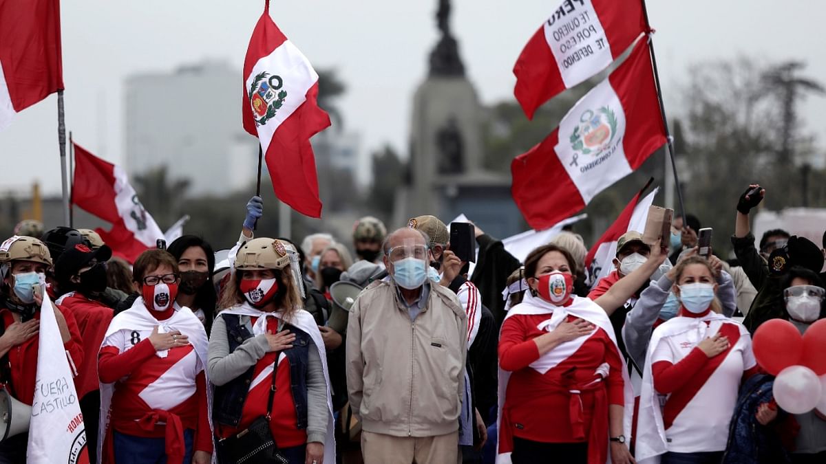 Demonstrators sing Peru's national anthem during a protest against the government of President Pedro Castillo, in Lima, Peru. Credit: Reuters Photo