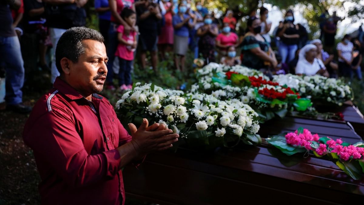 People take part in the funeral of 5 victims of the Linares family, found in a clandestine mass grave discovered in the house of a former policeman in Chalchuapa, in San Sebastian Salitrillo, El Salvador. Credit: Reuters Photo