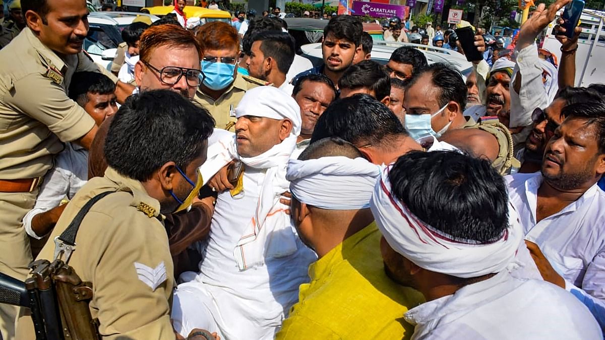 Police personnel detain Congress leader Ajay Rai during his participate in 'wheel jam' protest against Lakhimpur Kheri incident, in Varanasi. Credit: PTI Photo