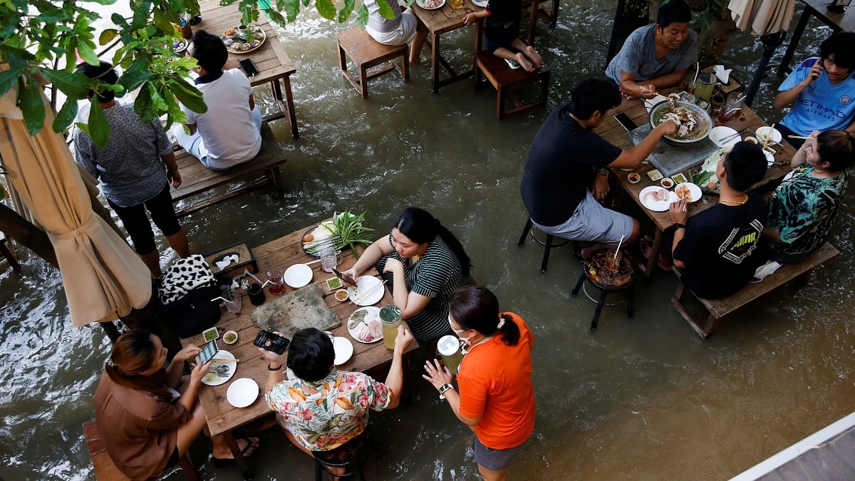 Now, instead of empty chairs and vacant tables, the Chaopraya Antique Café is as full as ever, offering an experience the canny owner calls “hot-pot surfing.” Credit: Reuters Photo