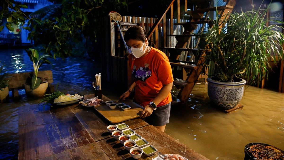 Riverside restaurant owner Titiporn Jutimanon was convinced a bout of flooding in Thailand could be the end of a business already struggling from the pandemic. Credit: Reuters Photo