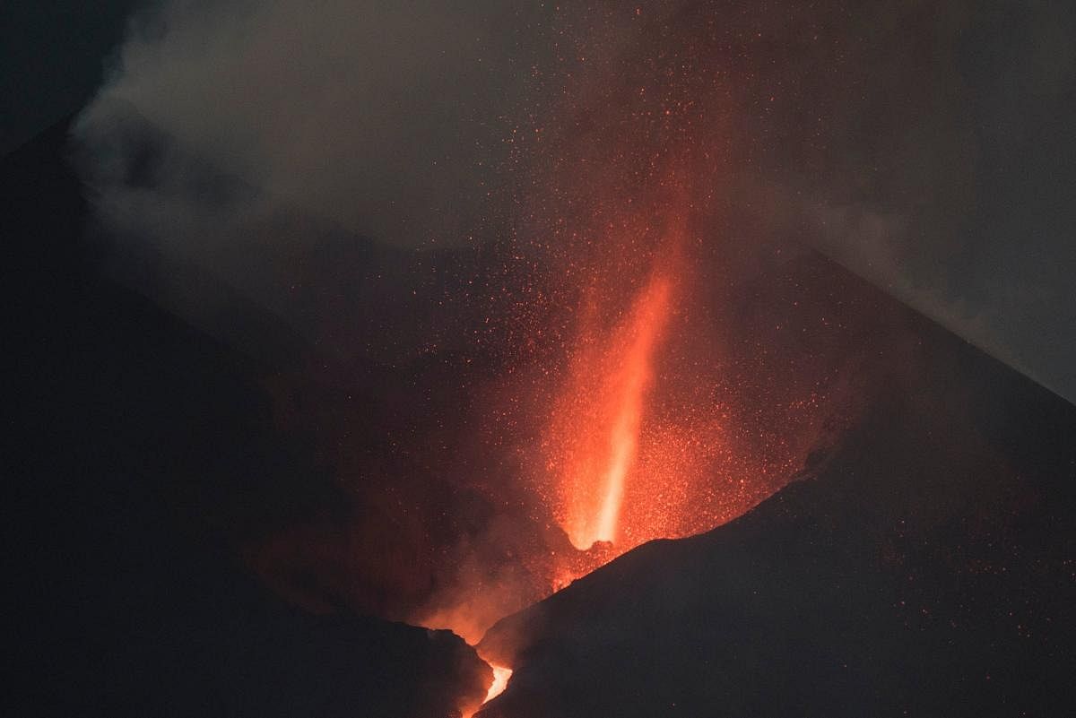 The Cumbre Vieja volcano, pictured from Los Llanos de Aridane, spews lava, ash and smoke, in the Canary Island of La Palma at night. Credit: AFP Photo