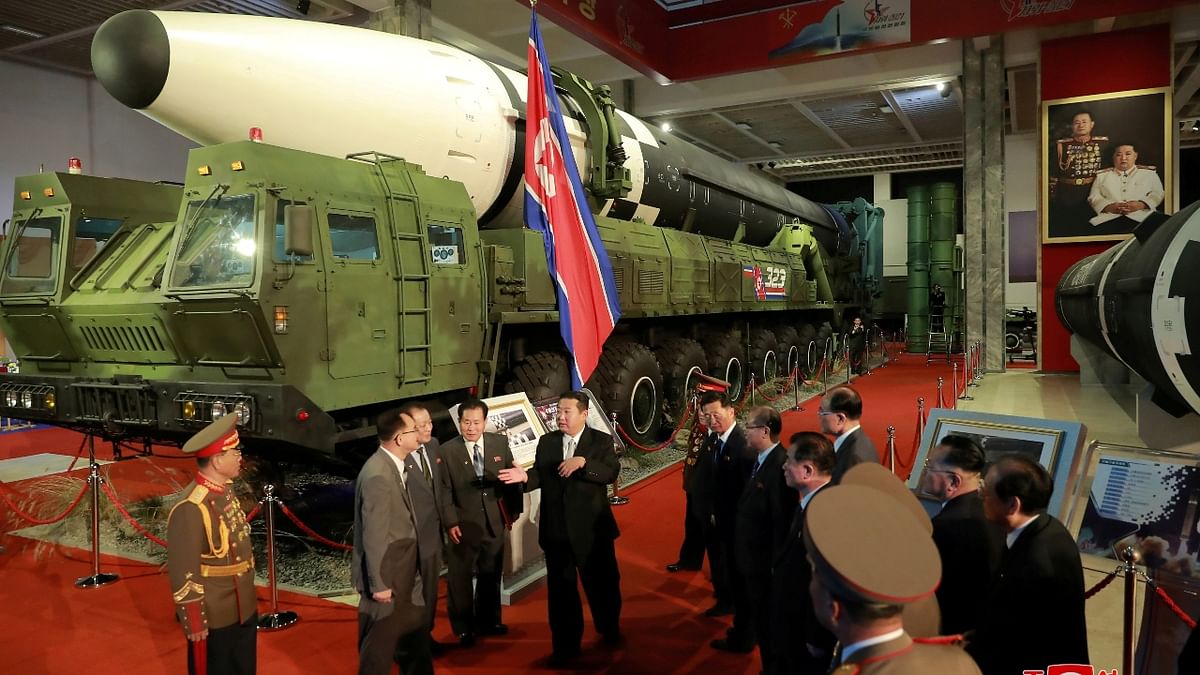 North Korea's leader Kim Jong Un speaks to officials next to military weapons and vehicles on display, including the country's intercontinental ballistic missiles (ICBMs), at the Defence Development Exhibition, in Pyongyang, North Korea. Credit: KCNA via Reuters