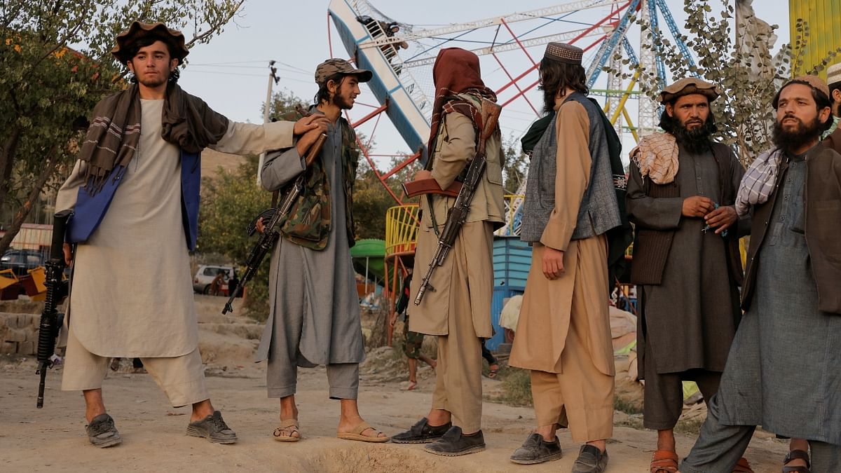 Strolling casually with their machine guns in hand, Halimi and many of his fellow Taliban fighters enjoyed a rare day off with a visit to a popular waterside amusement park in Kabul. Credit: Reuters Photo
