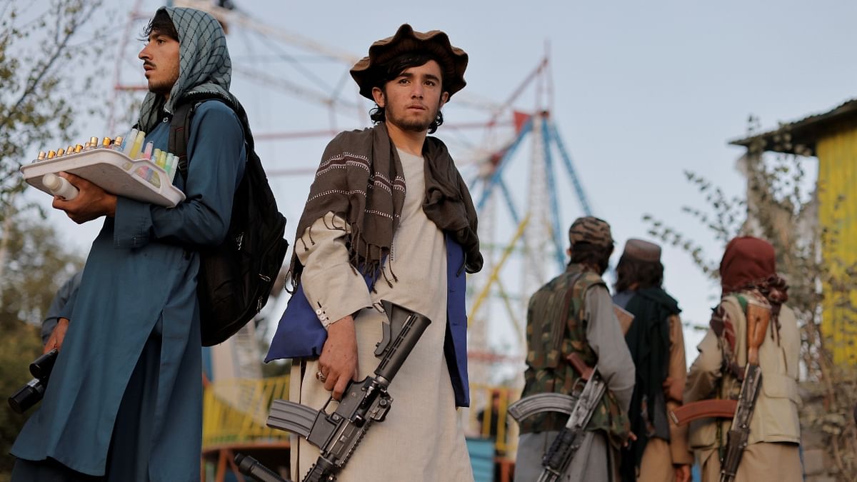 A Taliban fighter looks on as he and others enjoy their day off at an amusement park in Kabul. Credit: Reuters Photo