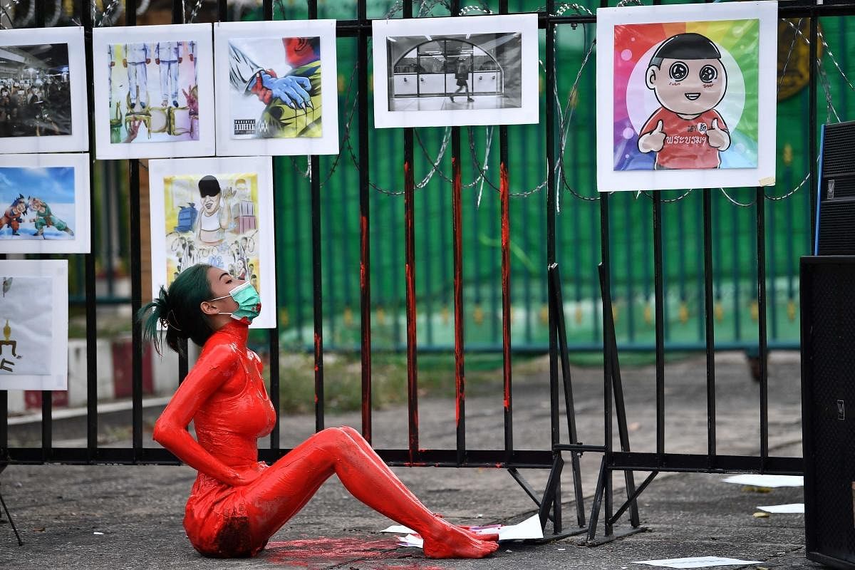 A protester is covered in red paint during a demonstration against the government of Thailand's Prime Minister Prayut Chan-O-Cha and in support of the release of political prisoners outside Bangkok Remand Prison in Bangkok. Credit: AFP Photo