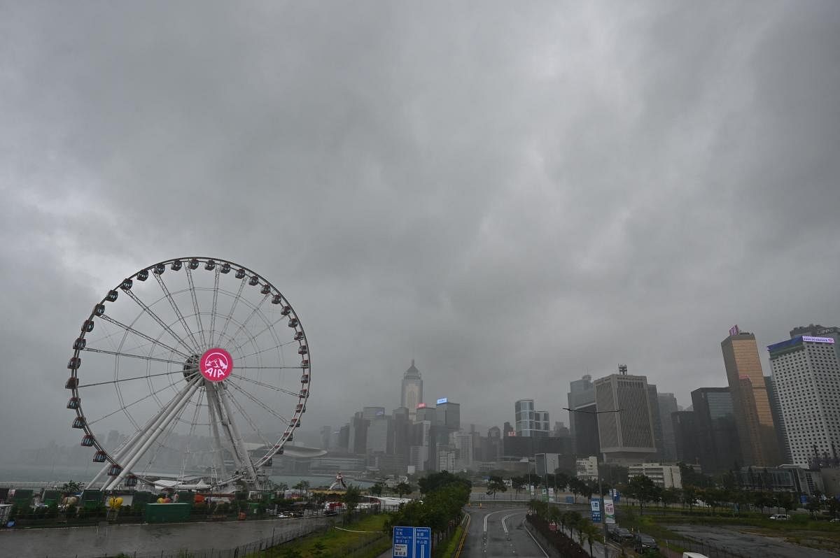 Rain clouds are seen over the Central business district as Hong Kong battened down for the second time in less than a week as Tropical Cyclone Kompasu prompted forecasters to raise their alert level and usher in mandatory safety measures. Credit: AFP Photo