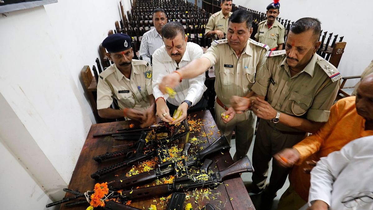 Police officers offer prayers to their weapons to mark 'Shastra Puja' on the occasion of Dussehra festival at the headquarters in Ahmedabad. Credit: PTI Photo