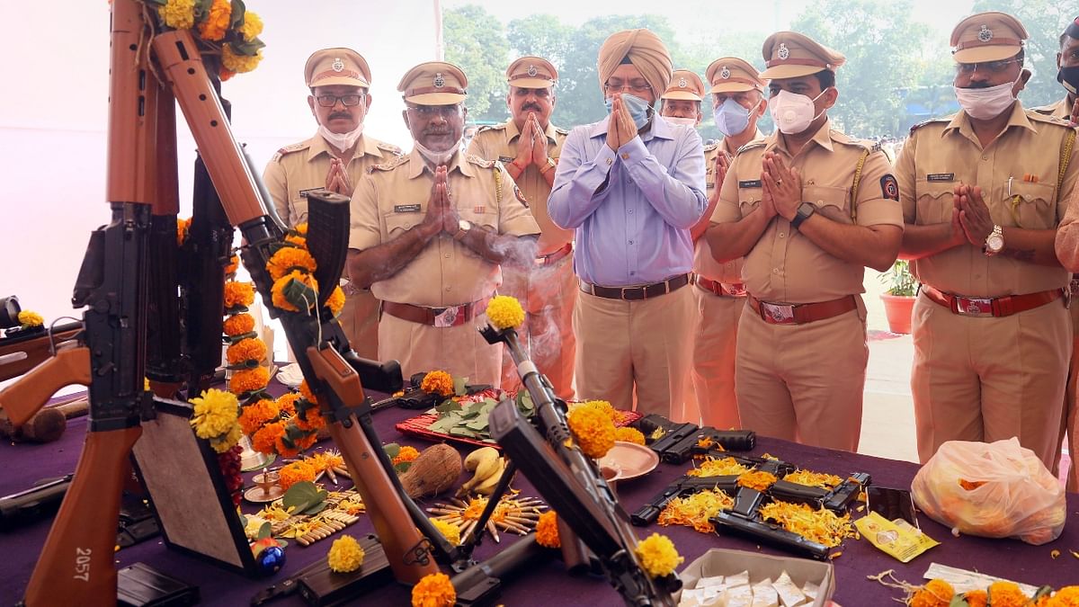 Police officers perform 'Shastra Pooja' on the occasion of Dussehra festival in Thane. Credit: PTI Photo