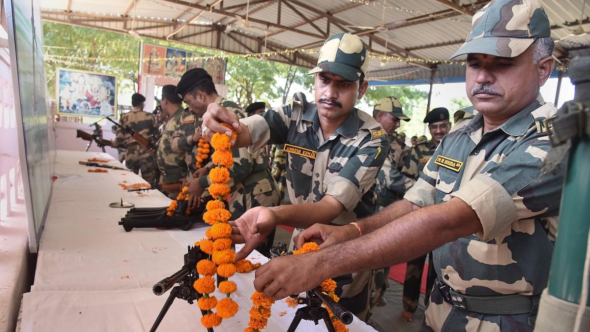 BSF soldiers perform puja of their weapons to mark ‘Shastra Puja' on the occasion of 'Vijaya Dashami' in Bikaner. Credit: PTI Photo